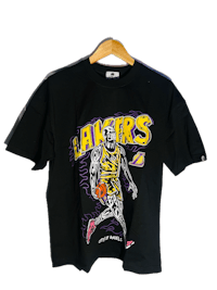 a black t - shirt with an image of the los angeles lakers