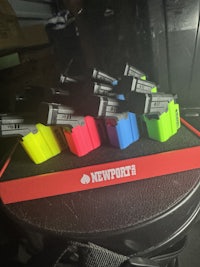 a group of different colored flashlights sitting on a table